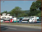 Large tour buses occupy the road.