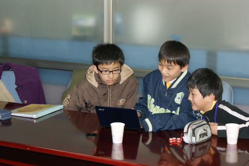 Students using mini-laptop to type report 
